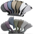 Set of baseball caps in various colors displayed on stands.